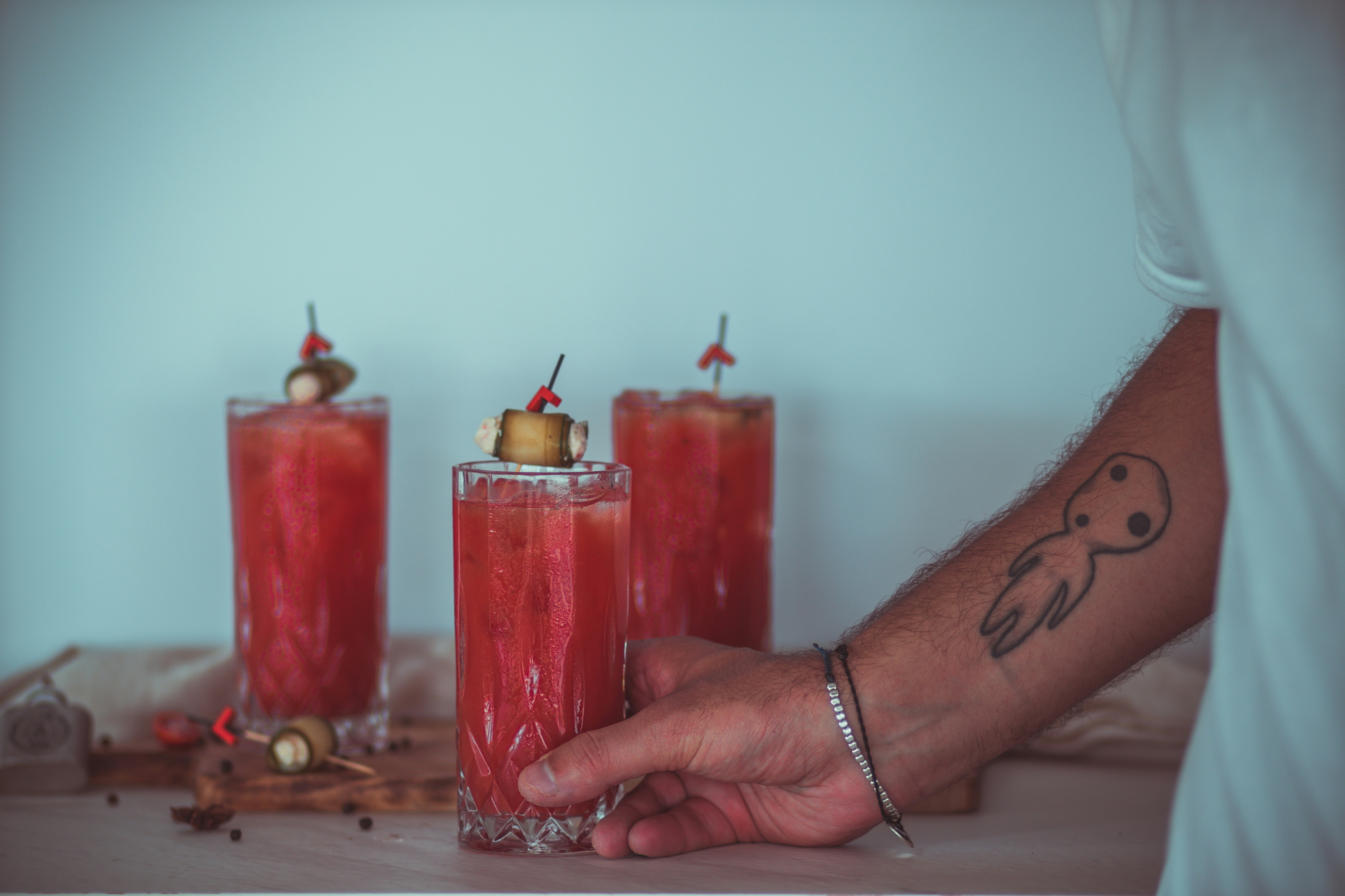 person holding red pillar candles